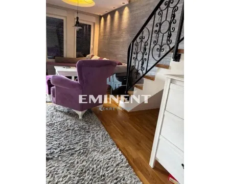 Living room with a purple armchair, sofa, and staircase. - image 5
