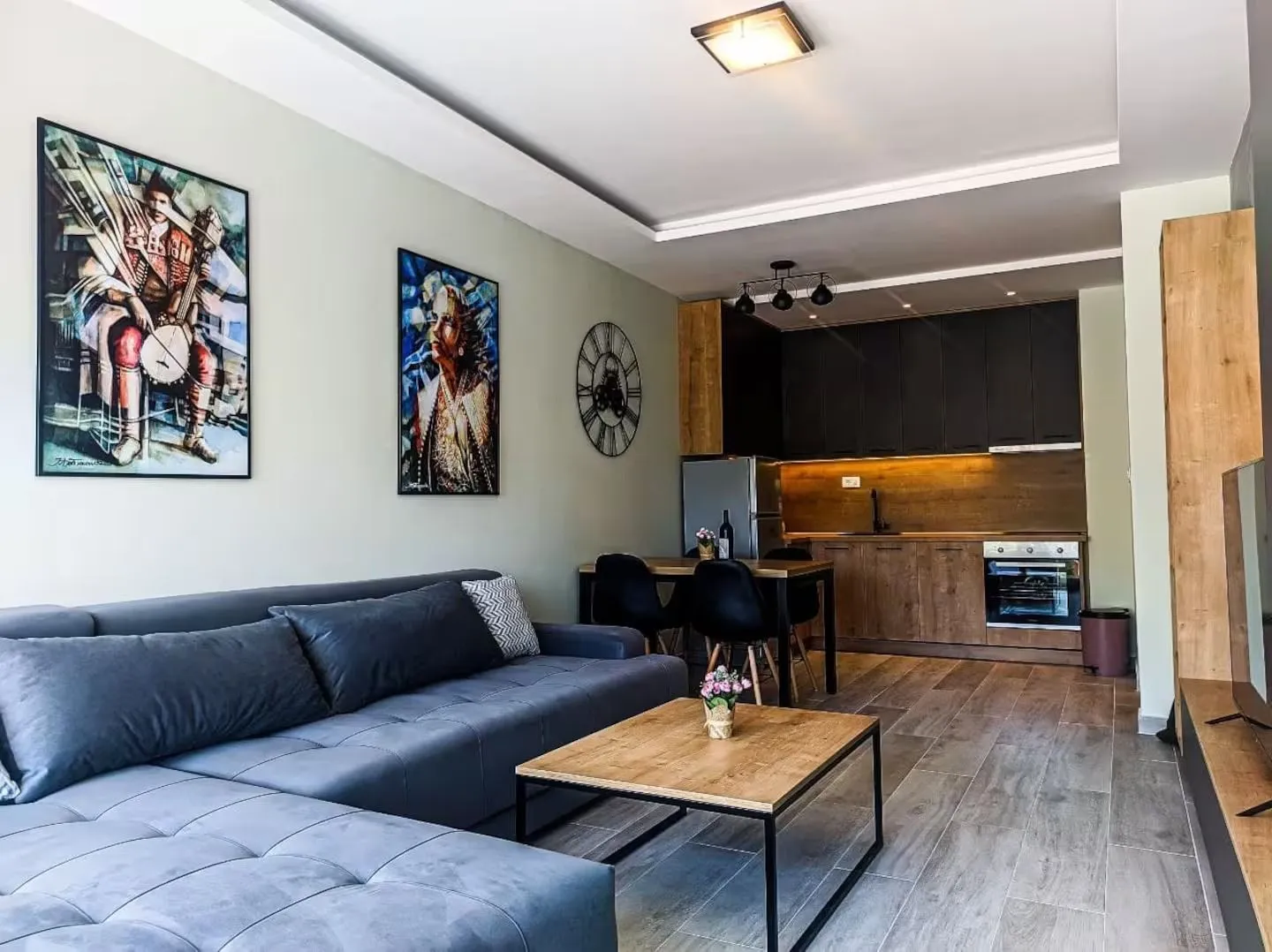 Modern living room with a sofa and dining area combined with the kitchen.