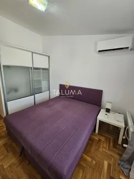 Bedroom with a double bed, wardrobe, and air conditioning unit. - image 6