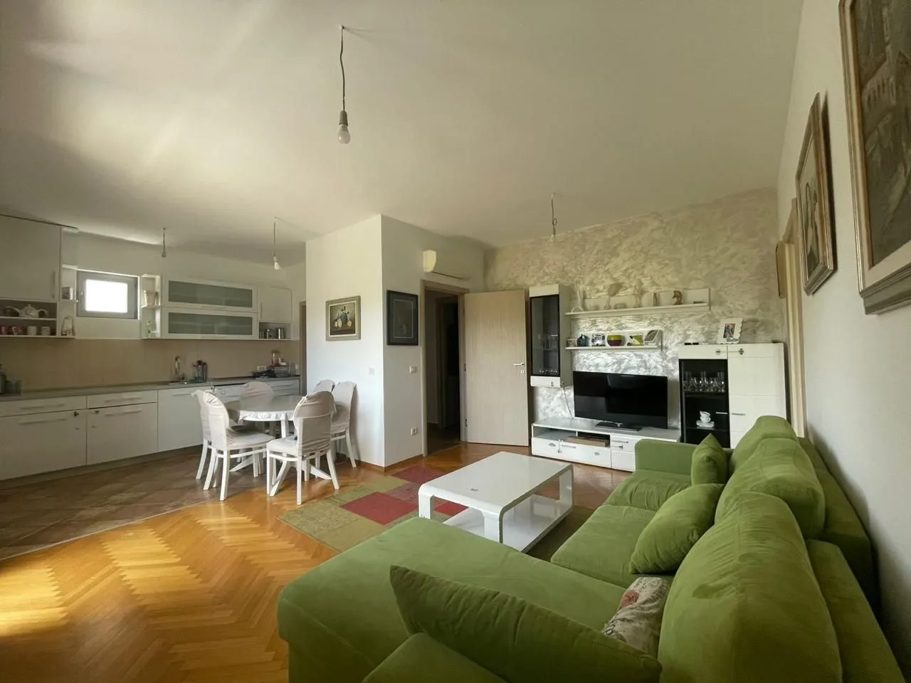 Spacious living room connected to the dining area and kitchen.