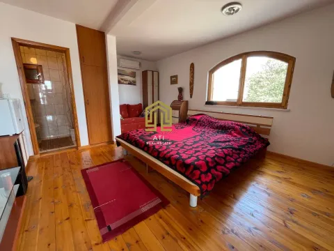 Bedroom with a double bed, wooden flooring, and an en-suite bathroom. - image 8