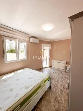 Bedroom with a bed, air conditioning unit, and a window. - image 10