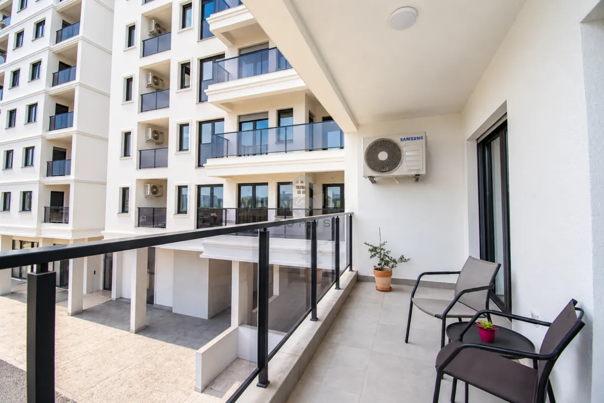 Furnished balcony with seating set and a view of the building.