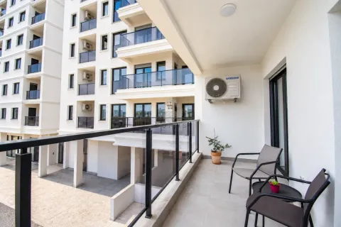 Furnished balcony with seating set and a view of the building. - image 2