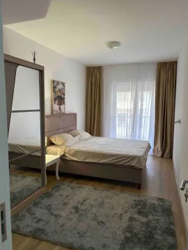 Furnished bedroom with a double bed, large mirrored wardrobe, and terrace access. - image 4