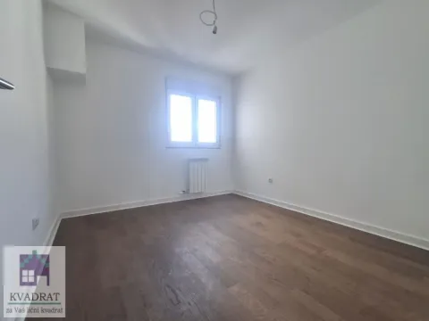 Empty room with white walls, wooden flooring, and a single window. - image 12