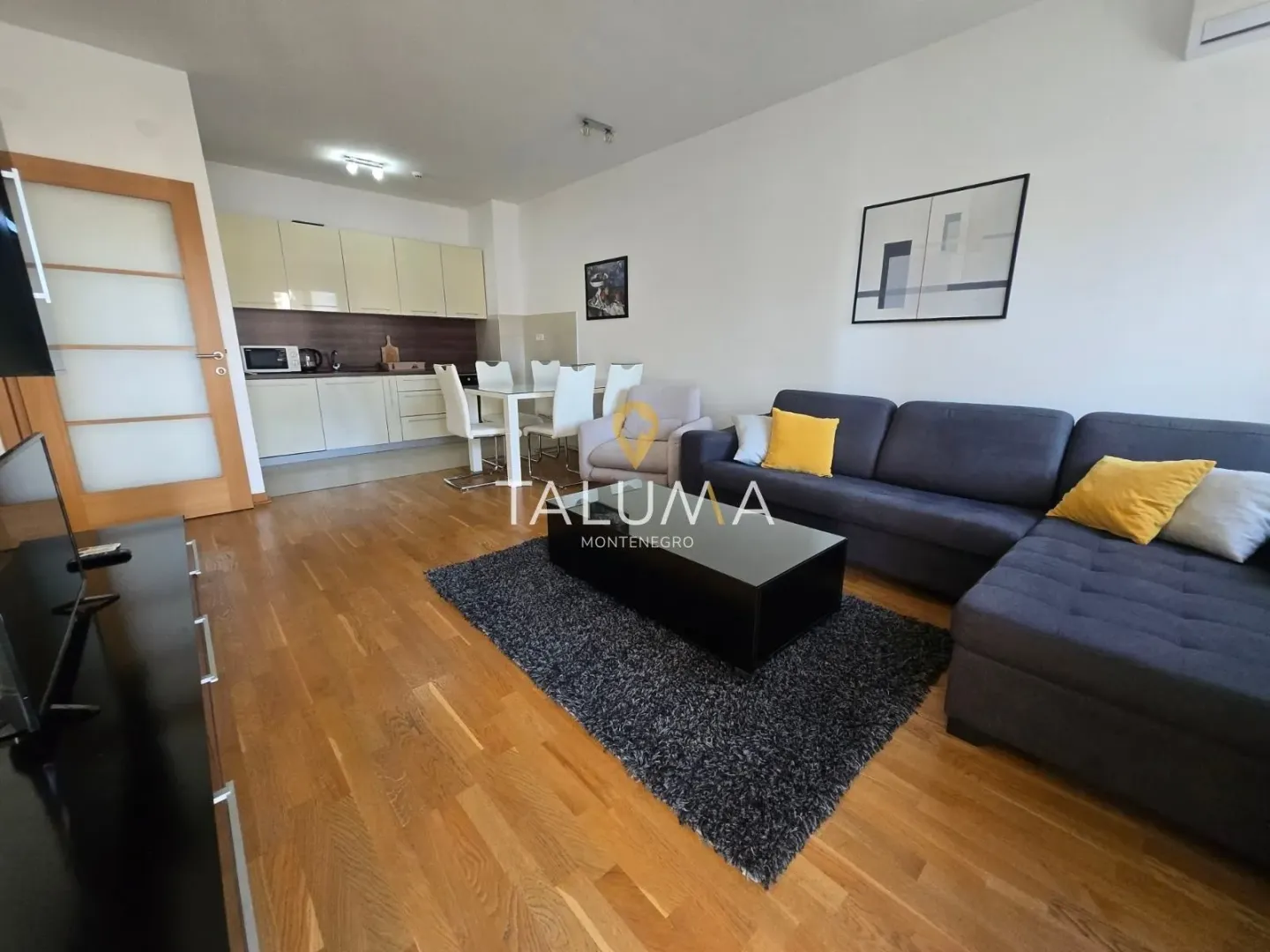 Living room connected with the dining area and kitchen.