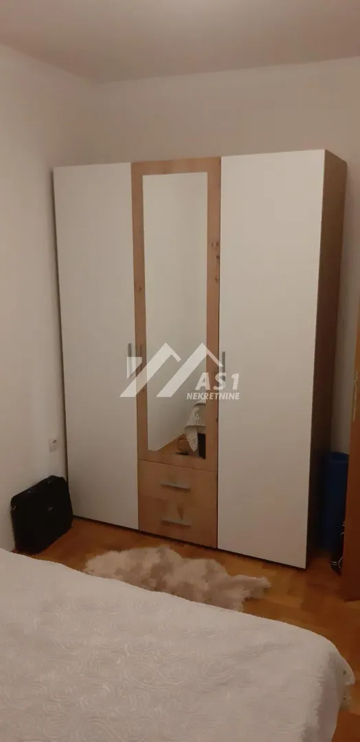 Bedroom with a large wardrobe and bed.