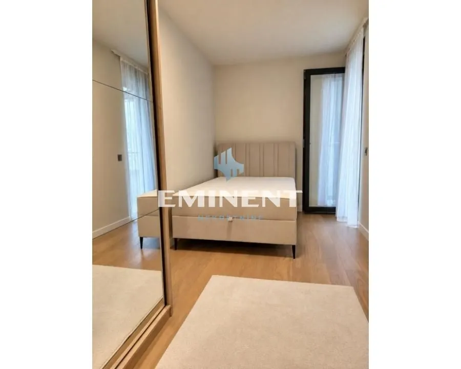 Bedroom with a double bed and a fitted wardrobe with a mirror.
