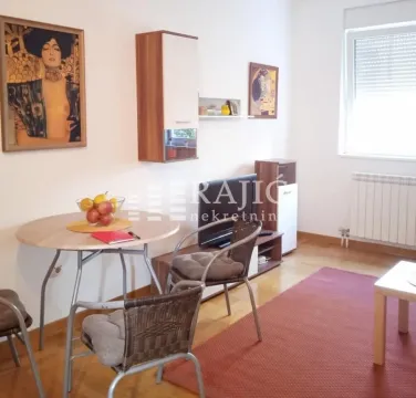 Living room with a dining table and chairs. - image 2