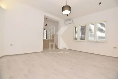 Empty living room with white walls, light flooring, and a view towards the passage to another room. - image 4