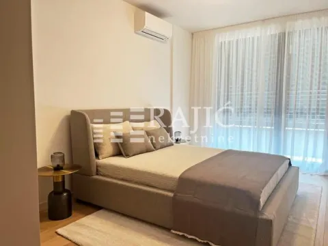 Modern bedroom with a double bed and air conditioning. - image 3