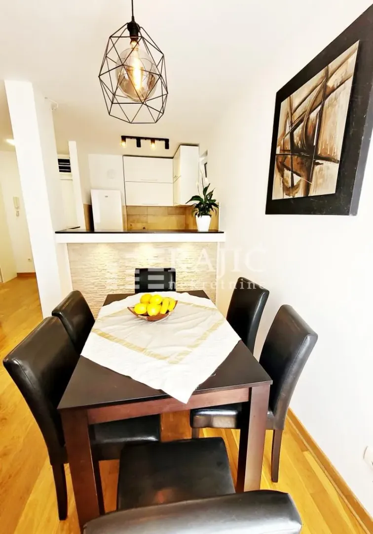 Dining area with a table and chairs overlooking the kitchen.