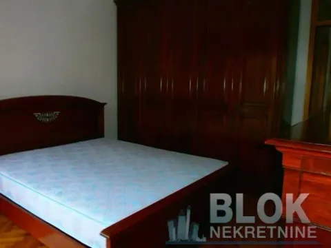 Bedroom with a double bed and a wooden wardrobe. - image 8