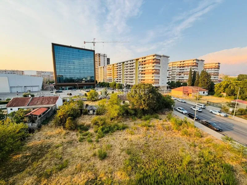 Aerial view of a building plot and surrounding buildings.