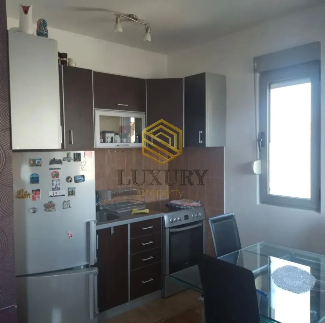 Smaller kitchen with a dining table and window.