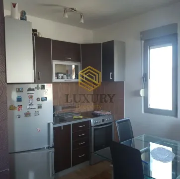 Smaller kitchen with a dining table and window. - image 5