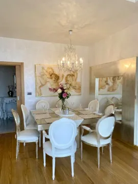 Dining room with dining table, chairs, and chandelier. - image 3