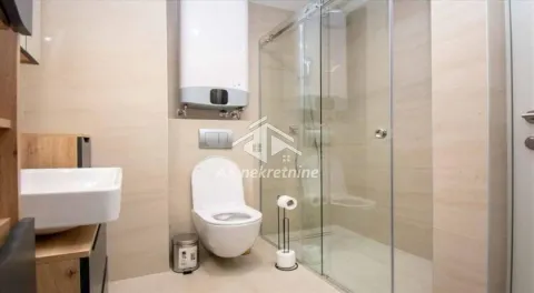 Modern bathroom with a shower cabin, toilet, and washbasin. - image 8