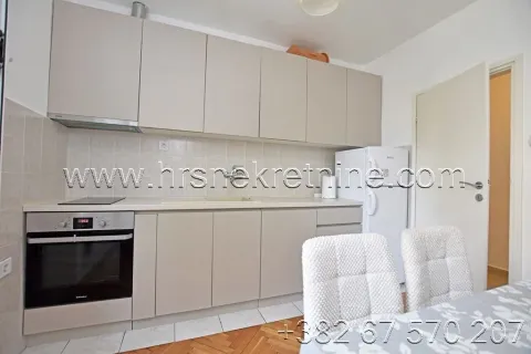 Small kitchen with light-colored cabinets and built-in home appliances. - image 10