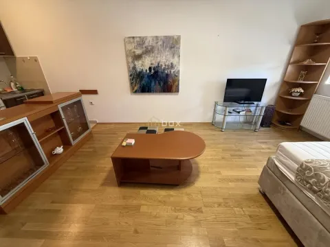 Living room with wooden furniture, a television, and parquet flooring. - image 2