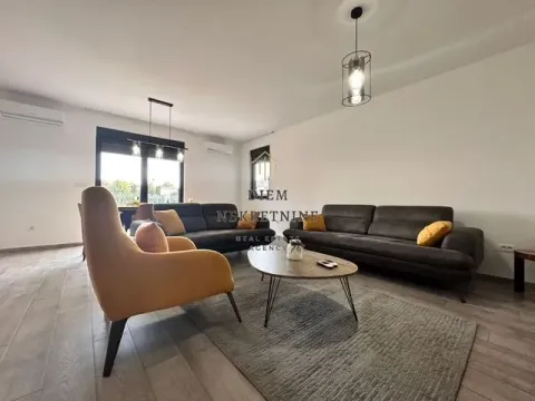 Spacious and bright living room with a sofa set and a dining area in the background. - image 2