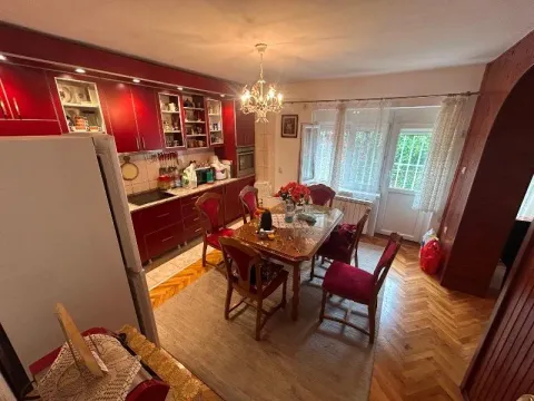 Kitchen with dining area and red cabinetry. - image 18