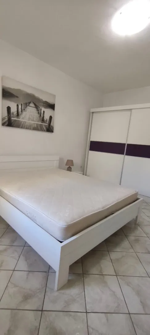 Bedroom with a double bed, wardrobe, and a wall picture.