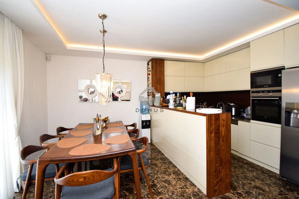 Kitchen with a dining area and a wooden table.