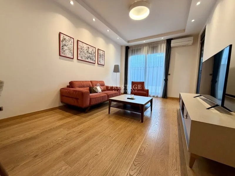 Modern and bright living room with a sofa and TV.
