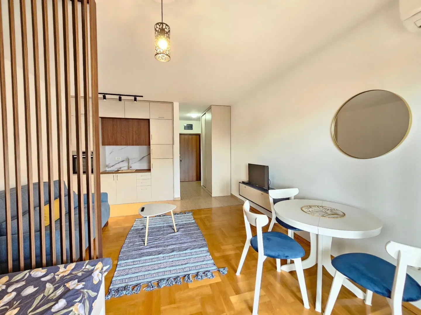 Living room with a dining area and kitchen in the background.