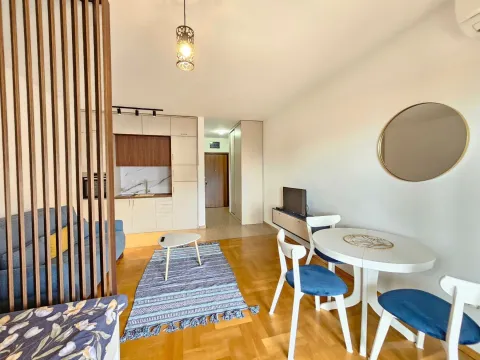 Living room with a dining area and kitchen in the background. - image 2