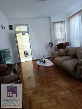 Living room with a sofa, coffee table, and parquet flooring. - image 4