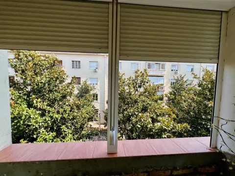 View from the terrace facing a neighboring building and trees. - image 10