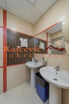 Bathroom with two washbasins and wall tiling. - image 18
