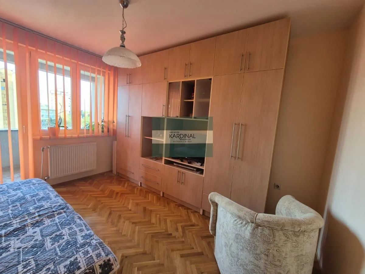 Nameštena spavaća soba sa velikim garderoberom i krevetom.