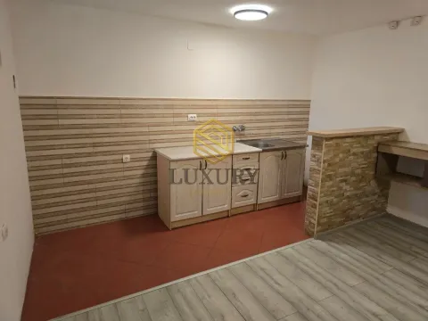 Small kitchen with cabinets and sink. - image 2