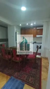 Dining area with a table and chairs and a kitchen in the background. - image 11