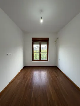 Empty room with wooden flooring and a window. - image 5
