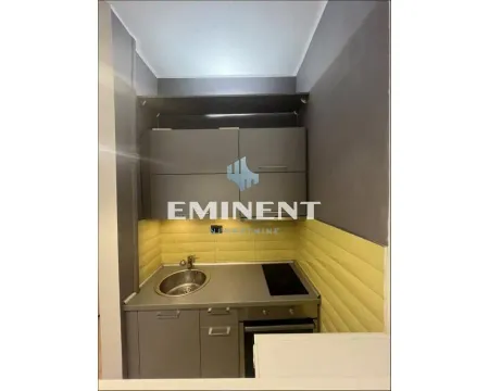 Smaller kitchen with grey cabinets and a sink. - image 12