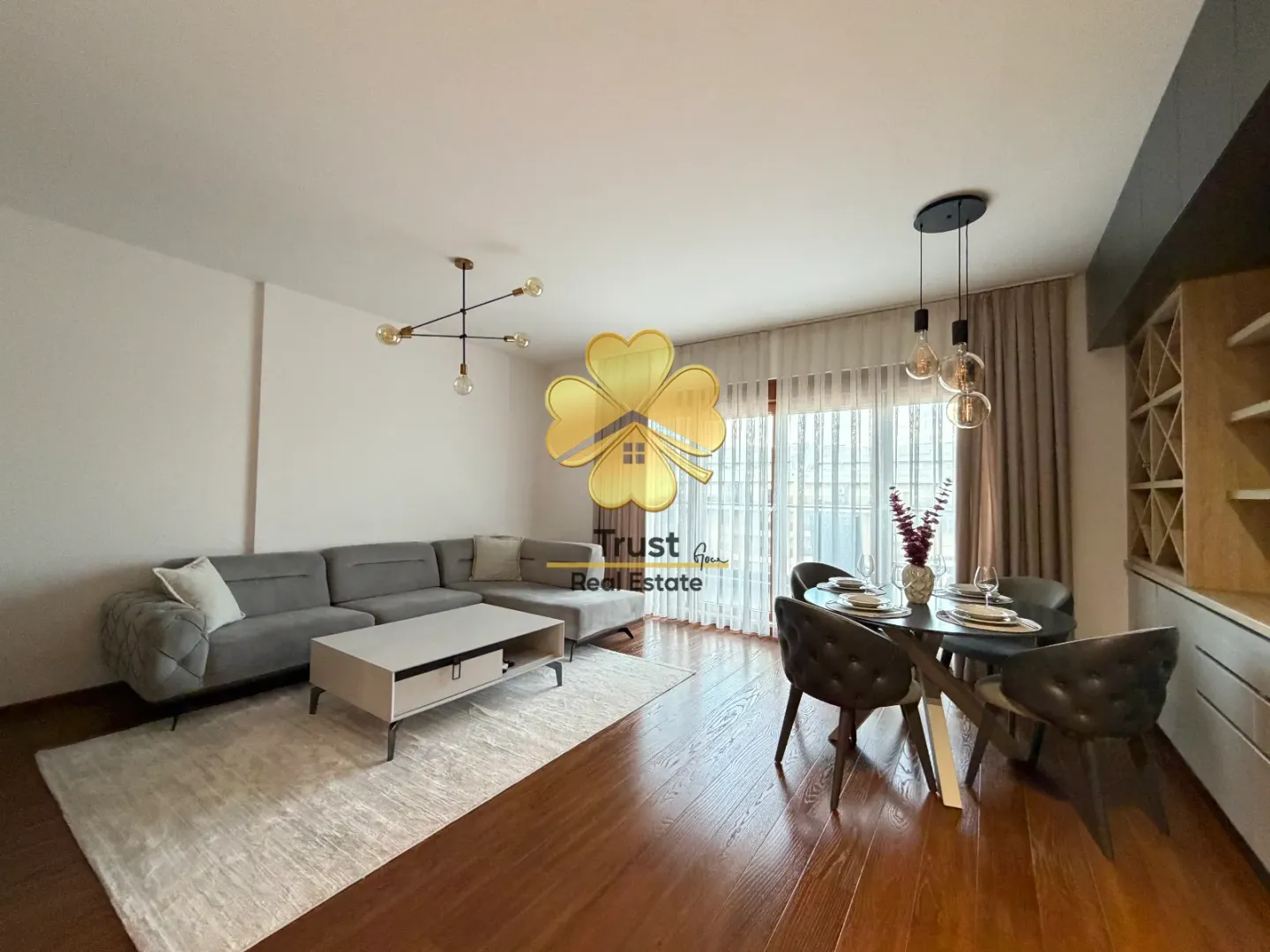 Spacious living room with sofa set and dining area.