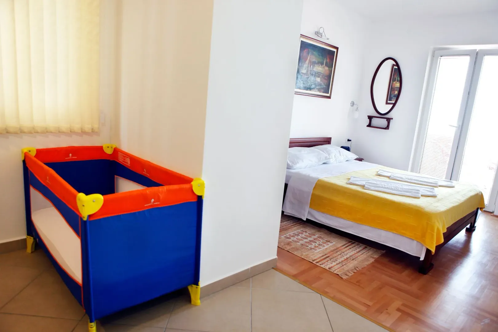 Bedroom with a double bed and a baby cot.