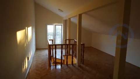 Empty attic space with a wooden staircase and parquet flooring. - image 18