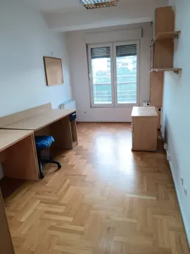Empty room with desks and wooden parquet flooring. - image 4