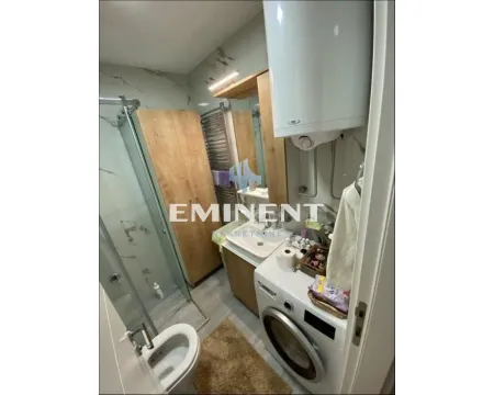 Equipped bathroom with a shower cabin, washbasin, and washing machine. - image 7