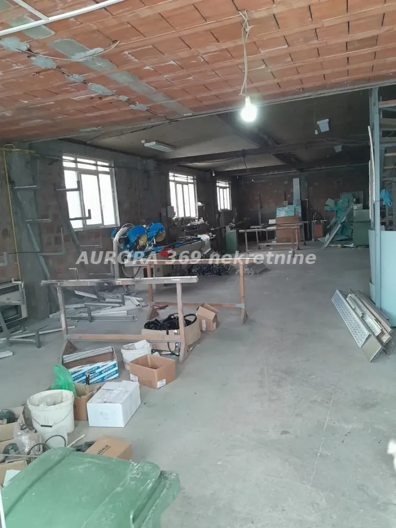 Interior of an unfinished commercial space in raw condition with tools and materials.