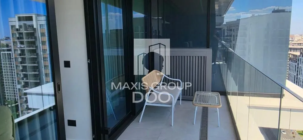 Modern terrace with glass railing and seating furniture.