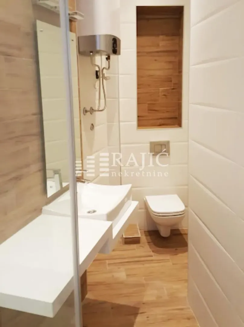 Modern bathroom equipped with a sink and toilet.