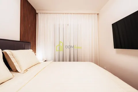 Bedroom with a double bed and a wall-mounted TV. - image 9