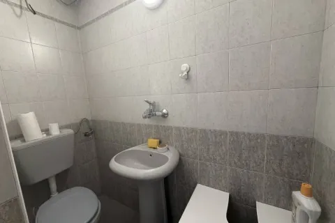 Small tiled bathroom with a sink and a toilet. - image 7